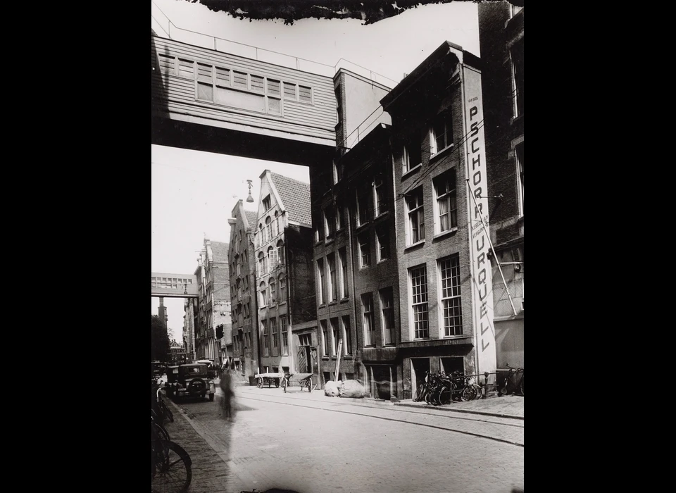 In de Beursstraat tussen 85 en 99 zijn meerdere panden als magazijn in gebruik bij De Bijenkorf bereikbaar via luchtbruggen (1935)