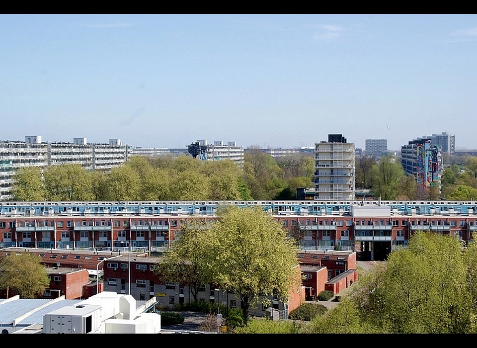 Hoptille gezien vanaf dak van Karspeldreef 15 laagbouw en 300 meter lange flat. Daar achter 
						de flats Hogevecht-Oost en -West (re) en Haag en Veld-Oost en -West (li) (2016).