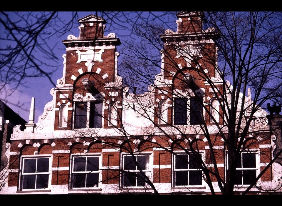 Singel 140-142 huis De Dolphijn, toppen trapgevel met rolornamenten (1986)